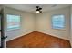 Cozy bedroom featuring hardwood floors, a ceiling fan, and two windows with natural light at 3113 Bellgreen Way, Decatur, GA 30032