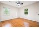 Empty bedroom featuring hardwood floors, and two windows at 3113 Bellgreen Way, Decatur, GA 30032