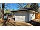 Exterior view featuring a modern detached garage, a covered patio and a backyard fence at 3113 Bellgreen Way, Decatur, GA 30032