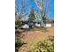 Exterior home view with red brick, white paint, a well-maintained yard and mature trees at 3113 Bellgreen Way, Decatur, GA 30032