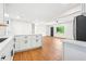 Bright kitchen with white cabinets, modern appliances, and hardwood floors at 3113 Bellgreen Way, Decatur, GA 30032