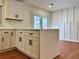 Stylish kitchen island with white cabinets and view to the backyard at 3113 Bellgreen Way, Decatur, GA 30032