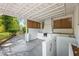 Covered outdoor kitchen with a built-in grill, countertops, and stone patio at 3113 Bellgreen Way, Decatur, GA 30032
