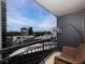 Condo balcony with a wicker chair and views of the city skyline at 3481 Lakeside Ne Dr # 1705, Atlanta, GA 30326