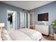 Bright bedroom features a walk-in closet, a dresser with a TV and a plant. It is freshly painted with a white bed at 3481 Lakeside Ne Dr # 1705, Atlanta, GA 30326