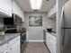 A modern kitchen with stainless steel appliances, white cabinets, and granite countertops at 3481 Lakeside Ne Dr # 1705, Atlanta, GA 30326