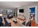 View of a stylish, staged living room with modern furnishings, hardwood floors, and bedroom in the background at 3481 Lakeside Ne Dr # 1705, Atlanta, GA 30326