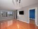 Open concept living room with hardwood floors, a view to a bedroom, and large windows at 3481 Lakeside Ne Dr # 1705, Atlanta, GA 30326