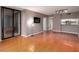 Hardwood floors in this living room with a view to the kitchen and a sliding glass door at 3481 Lakeside Ne Dr # 1705, Atlanta, GA 30326