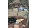 Backyard view of fire pit, natural log perimeter seating, bridge and lush landscaping at 904 Kings Ne Ct, Atlanta, GA 30306