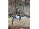 Secluded backyard features a rustic outdoor seating area with a stone fireplace and gravel base at 904 Kings Ne Ct, Atlanta, GA 30306