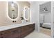 Bright bathroom featuring double vanity, modern lighting and mirrors with a view into the primary bedroom at 904 Kings Ne Ct, Atlanta, GA 30306