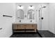 This bathroom features a modern double sink vanity, arched mirrors, and a glass-enclosed shower at 904 Kings Ne Ct, Atlanta, GA 30306