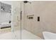 Bright bathroom with glass shower and seamless showerhead in a room featuring uniquely patterned tile at 904 Kings Ne Ct, Atlanta, GA 30306