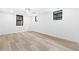 A modern bedroom features gray wood-look flooring, a ceiling fan, and three windows to let in natural light at 904 Kings Ne Ct, Atlanta, GA 30306