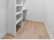 Walk-in closet with custom shelving and hardwood floors at 904 Kings Ne Ct, Atlanta, GA 30306