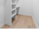 Walk-in closet with hardwood floors, and built-in shelving at 904 Kings Ne Ct, Atlanta, GA 30306