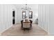 Elegant dining room featuring modern chandelier, long wooden table, and panelled wall design at 904 Kings Ne Ct, Atlanta, GA 30306
