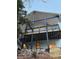 Back of the house featuring multiple tiers, wood supports, and a black iron fence at 904 Kings Ne Ct, Atlanta, GA 30306