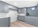 Laundry and pet washing area with gray cabinets and a tiled wash station at 904 Kings Ne Ct, Atlanta, GA 30306