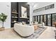 A bright and airy living room featuring a modern fireplace and large windows overlooking a deck at 904 Kings Ne Ct, Atlanta, GA 30306