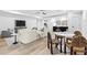 Open living room area with ample seating, light hardwood floors, and an adjacent dining area at 904 Kings Ne Ct, Atlanta, GA 30306