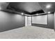 Basement movie room with a large screen, dark walls, recessed lighting, and gray carpet at 904 Kings Ne Ct, Atlanta, GA 30306