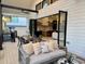 Comfortable outdoor seating on this modern patio with view into the home's stylish kitchen at 904 Kings Ne Ct, Atlanta, GA 30306