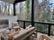 Covered patio with seating area and fireplace overlooks a serene wooded setting at 904 Kings Ne Ct, Atlanta, GA 30306