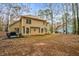 Spacious backyard with a patio and wooded surroundings, providing privacy and nature views at 1605 Loblolly Ln, Cumming, GA 30041