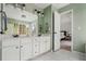 Bathroom featuring double sinks and doorway that leads into bedroom at 1605 Loblolly Ln, Cumming, GA 30041