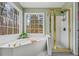 Bright bathroom features a soaking tub and glass shower with gold trim, offering a serene retreat at 1605 Loblolly Ln, Cumming, GA 30041