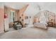 A serene bedroom with peach walls, chair, plush carpet, and a cozy reading nook at 1605 Loblolly Ln, Cumming, GA 30041