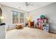 Bright, neutral room features a large window, a ceiling fan and carpet at 1605 Loblolly Ln, Cumming, GA 30041