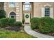 Inviting front entrance with lush landscaping, a wreath, and stone accents at 1605 Loblolly Ln, Cumming, GA 30041