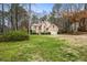 Charming home with well-manicured lawn and mature trees, showcasing curb appeal at 1605 Loblolly Ln, Cumming, GA 30041