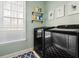 Well-organized laundry room featuring modern appliances and custom shelving at 1605 Loblolly Ln, Cumming, GA 30041
