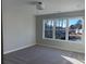 Bright, carpeted bedroom featuring a large window overlooking serene, wooded backyard at 3352 Cranston Ln, Kennesaw, GA 30144