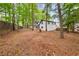 A beautiful wooded backyard with greenery is surrounded by mature trees at 3900 Millwood Lane Nw, Lilburn, GA 30047