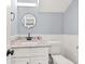 Bathroom features a white vanity with modern granite countertop and hardware, and white fixtures at 3900 Millwood Lane Nw, Lilburn, GA 30047