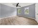 Spacious bedroom with light hardwood floors, two windows and light-blue walls, providing ample light at 3900 Millwood Lane Nw, Lilburn, GA 30047