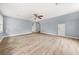 Open bedroom featuring light wood floors, fresh paint, and a ceiling fan at 3900 Millwood Lane Nw, Lilburn, GA 30047