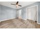Bedroom featuring light wood floors, fresh paint, a ceiling fan, and a walk-in closet at 3900 Millwood Lane Nw, Lilburn, GA 30047