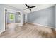 Bedroom with a ceiling fan, closet with mirrored doors, and light wood floors at 3900 Millwood Lane Nw, Lilburn, GA 30047