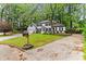 Traditional two-story home with a well-manicured lawn and mature trees at 3900 Millwood Lane Nw, Lilburn, GA 30047