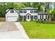 Charming two-story home with a two car garage and front lawn at 3900 Millwood Lane Nw, Lilburn, GA 30047