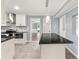 Well-lit kitchen showcasing an island with pendant lighting, stainless appliances, and marble backsplash at 3900 Millwood Lane Nw, Lilburn, GA 30047