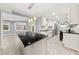 Open kitchen with island, stainless appliances, white cabinets, and adjoining dining area with large windows at 3900 Millwood Lane Nw, Lilburn, GA 30047