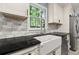 Farmhouse sink in modern kitchen with granite countertop and stainless steel appliances at 3900 Millwood Lane Nw, Lilburn, GA 30047