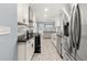 Bright kitchen features stainless steel appliances, black counter tops and grey marble back splash at 3900 Millwood Lane Nw, Lilburn, GA 30047